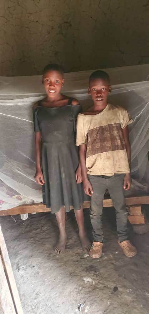 Two children standing together in a home supported by the foundation