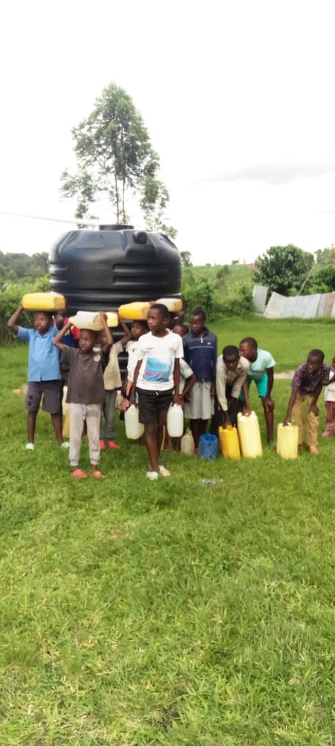 Children carrying water from a community water tank